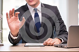 The young businessman pressing buttons in business concept