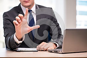 The young businessman pressing buttons in business concept