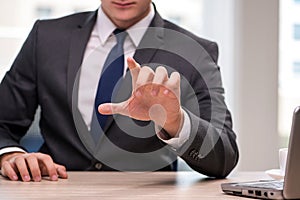 The young businessman pressing buttons in business concept