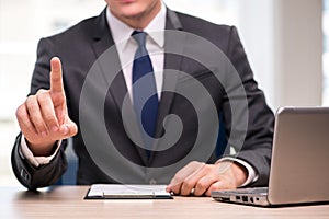 The young businessman pressing buttons in business concept