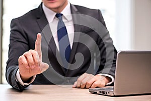 The young businessman pressing buttons in business concept