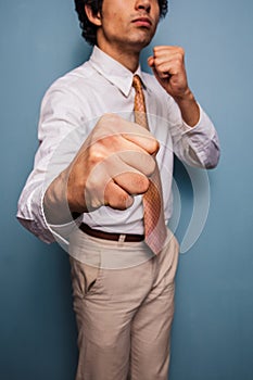 Young businessman punching