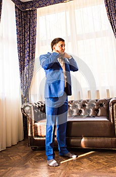 Young businessman putting on his jacket