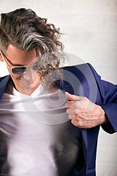 Young businessman putting on his jacket  over white.