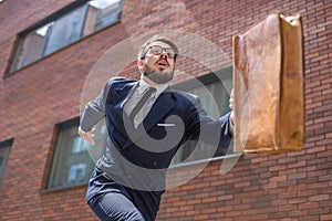 Young businessman running in a city street