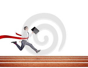 A young businessman running forward on track with a black folder in hand crossing the red finish line.