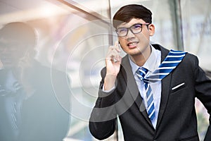 Young businessman running while talking on the mobile phone during rush hour. Business rushing concept
