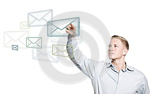 Young businessman selecting mail icon in the air.