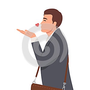 Young businessman sending a flying true love kiss, showing care, fondness and affection, a sincere Saint Valentine\'s message photo