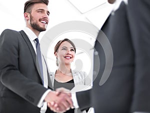 Young businessman shaking hands with his business partner