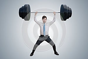 Young businessman in shirt is lifting heavy weights.