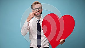 young businessman in shirt and tie on blue background