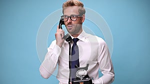 young businessman in shirt and tie on blue background