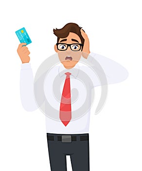 Young businessman shocked with hand on head for mistake, remember error. Forgot, bad memory. Person holding digital payment card.