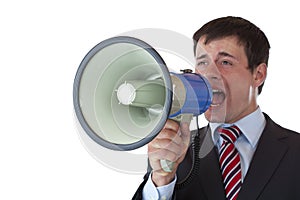 Young businessman shouts loudly into megaphone