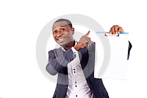 Young businessman showing blank paper on clipboard smiling