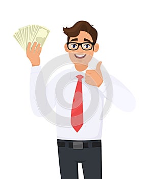 Young businessman showing cash, money and making thumb up gesture sign with hand fingers. Person holding currency notes.