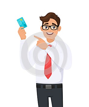 Young businessman showing credit, debit, ATM card and pointing finger. Person holding digital payment card. Male character design.