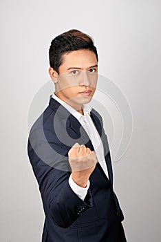 Young businessman showing a fist bump over white background