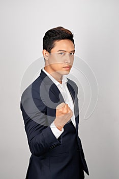 Young businessman showing a fist bump over white background