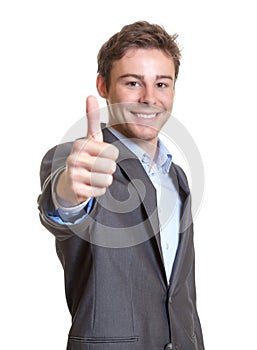 Young businessman showing thumb