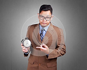Young Businessman Showing Time, Serious Expression