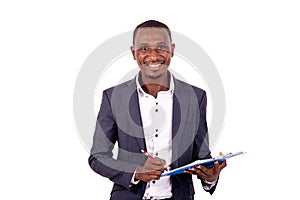 Young businessman signing document on clipboard smiling