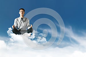 Young Businessman Siting on Cloud above the sky with Yoga meditation posture to find solution or wisdom, Supernatural photography