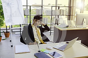 A young businessman is sitting down for a short break