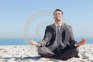 Young businessman sitting with legs crossed relaxing
