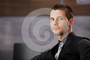 Young businessman sitting in modern office