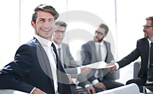 Young businessman sitting at the negotiating table