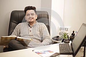 A young businessman is sitting in the office