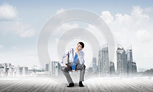 Young businessman sitting on an office chair