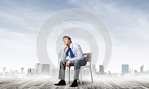 Young businessman sitting on an office chair