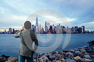 Young businessman with smartphone outdoor