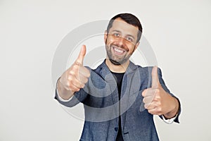 Young businessman with a smile man with a beard in a jacket, approving, making a positive hand gesture, thumbs up smiling and