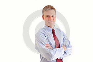 Young businessman smiling with arms crossed