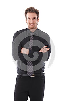 Young businessman smiling arms crossed