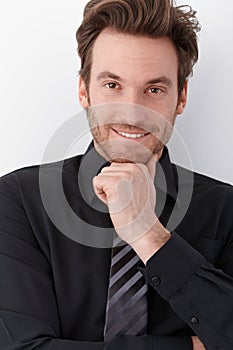 Young businessman smiling happily
