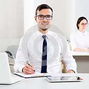 Young businessman smiling looking at camera