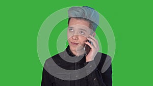 Young businessman speaking phone looking up green screen unpleasant conversation