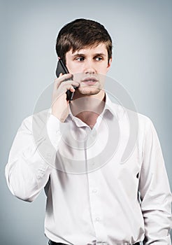 Young businessman speaks on the phone