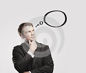 Young businessman with speech bubbles inside.