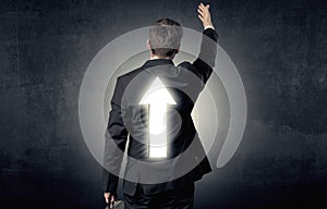 Young businessman standing with arrow on his back