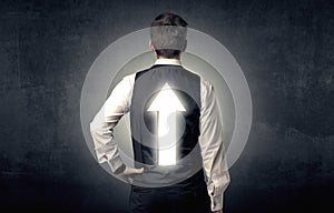 Young businessman standing with arrow on his back