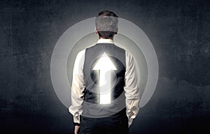 Young businessman standing with arrow on his back