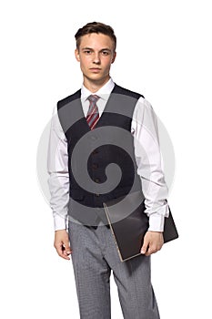 Young businessman standing with closed laptop in hus hand, isolated on white