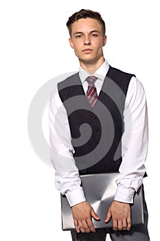 Young businessman standing with closed laptop in hus hands, isolated on white