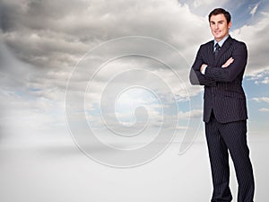 Young businessman standing crossarmed